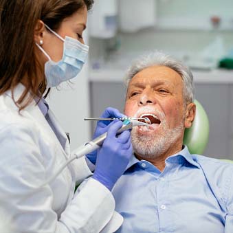 dentist looking in a man's mouth